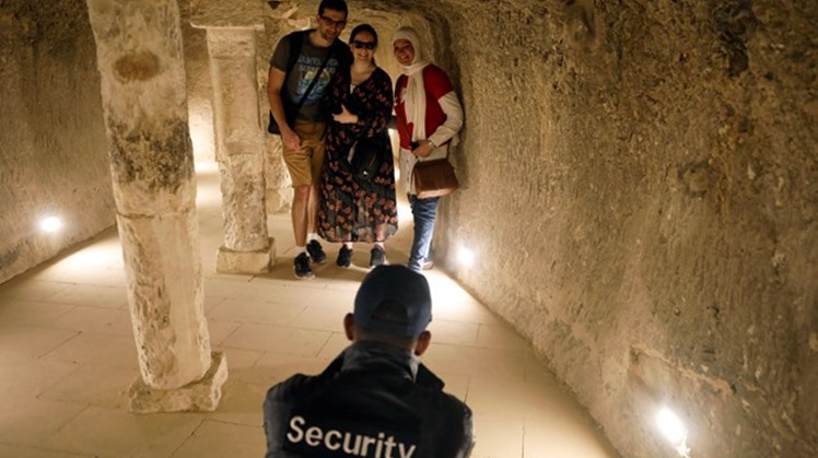 A security guard takes a photograph of tourists inside the standing step pyramid of Saqqara after its renovation, south of Cairo, Egypt March 5, 2020. REUTERS/Mohamed Abd El Ghany
