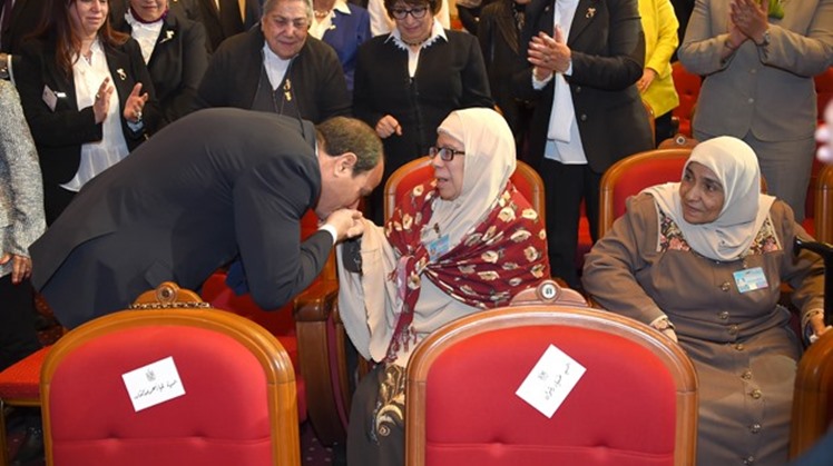 President Abdel Fatah al-Sisi kisses hand of an ideal mother on the Egyptian Woman Day-Press photo
